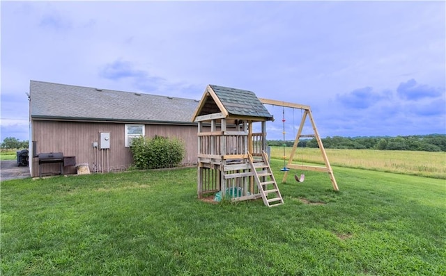 view of playground with a lawn