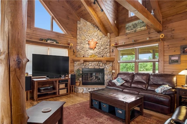 living room featuring wood ceiling, a fireplace, hardwood / wood-style flooring, and wood walls