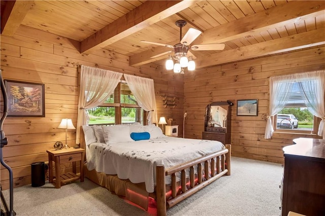 carpeted bedroom featuring multiple windows, wood ceiling, and beamed ceiling