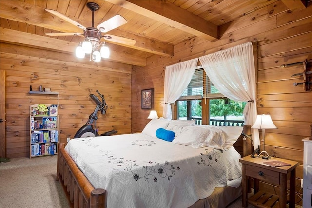 carpeted bedroom featuring beam ceiling, ceiling fan, wooden walls, and wood ceiling