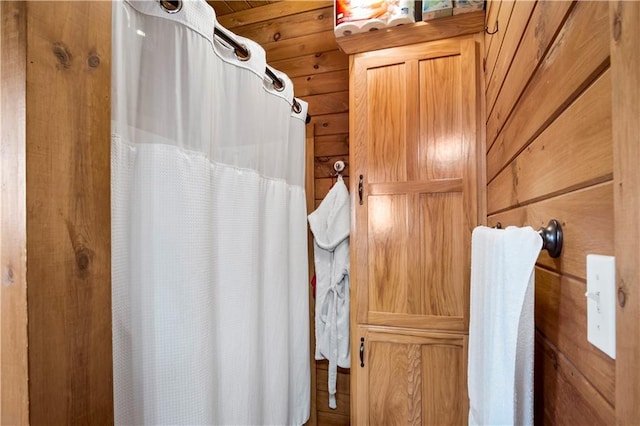 bathroom with wood walls