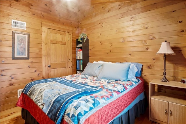 bedroom featuring wooden walls and a closet