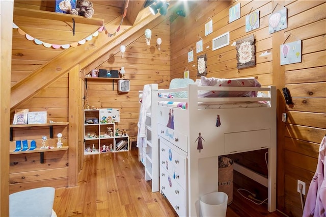 interior space with wooden walls and light hardwood / wood-style floors