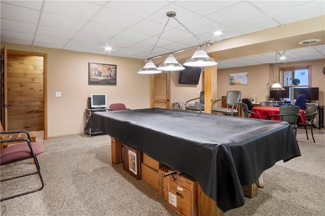 game room with a paneled ceiling and light carpet