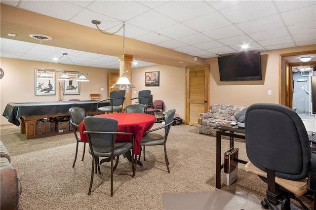 recreation room featuring a paneled ceiling and carpet flooring