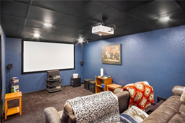 cinema room with carpet floors and a drop ceiling