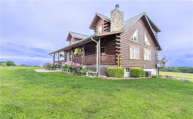 view of side of home featuring central air condition unit, covered porch, and a lawn