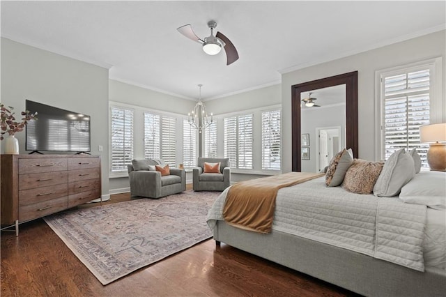 bedroom featuring ornamental molding, multiple windows, and wood finished floors