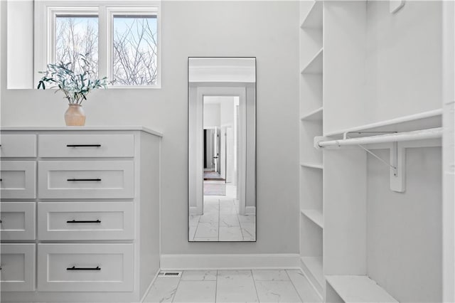 walk in closet featuring marble finish floor and visible vents