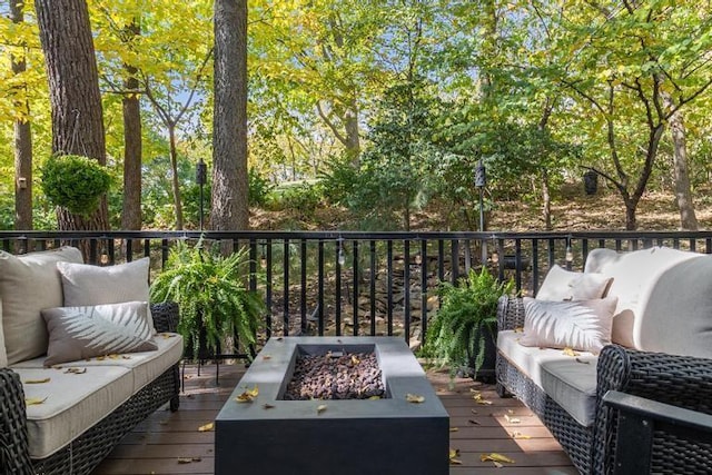 wooden deck with an outdoor living space with a fire pit