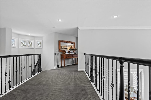 corridor featuring recessed lighting, baseboards, carpet flooring, and an upstairs landing