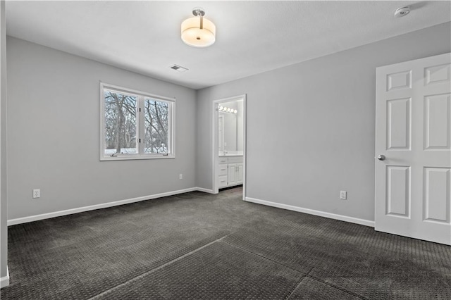 unfurnished bedroom with dark colored carpet, visible vents, and baseboards