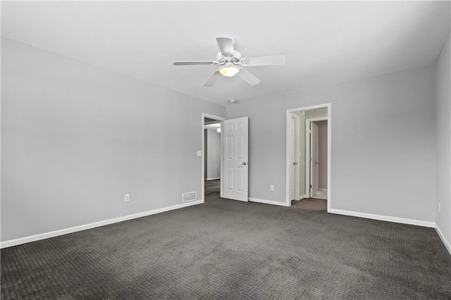 unfurnished bedroom with visible vents, dark colored carpet, a ceiling fan, and baseboards