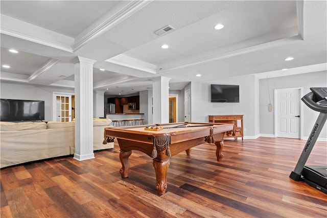 rec room with ornate columns, visible vents, a raised ceiling, and wood finished floors