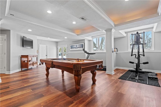 playroom featuring ornamental molding, wood finished floors, a raised ceiling, and visible vents