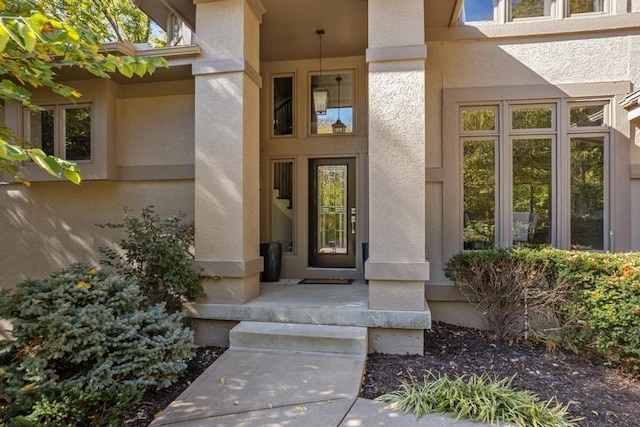 view of exterior entry with stucco siding