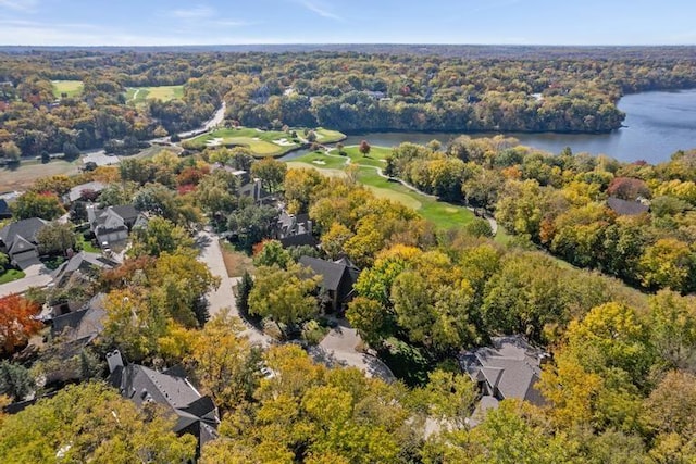 drone / aerial view featuring a water view and a wooded view