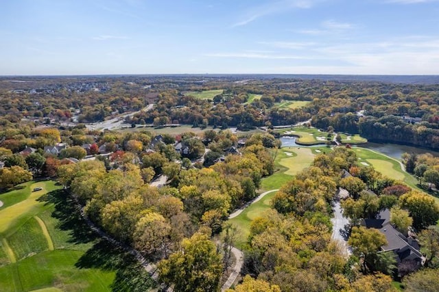 bird's eye view featuring view of golf course and a view of trees