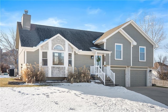 view of front of home with a garage and central air condition unit