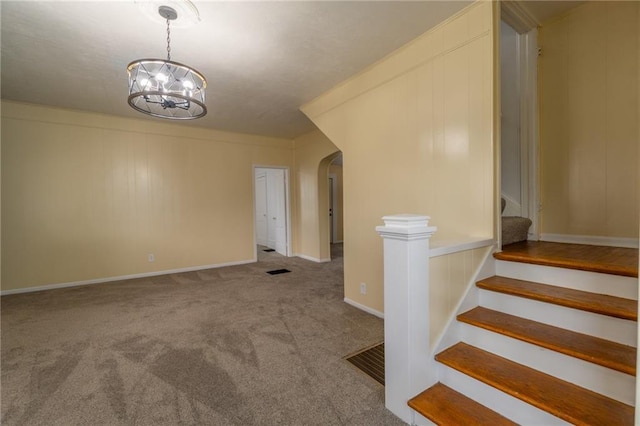 interior space featuring carpet floors and a chandelier