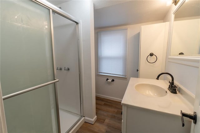 bathroom with an enclosed shower, vanity, and hardwood / wood-style floors