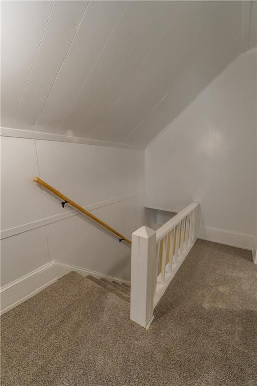 stairs featuring vaulted ceiling and carpet floors