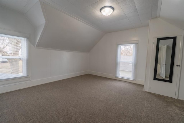 bonus room featuring lofted ceiling and carpet flooring