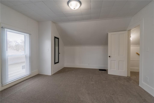 bonus room featuring vaulted ceiling and carpet flooring