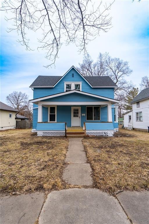 bungalow-style house featuring a porch and a front lawn