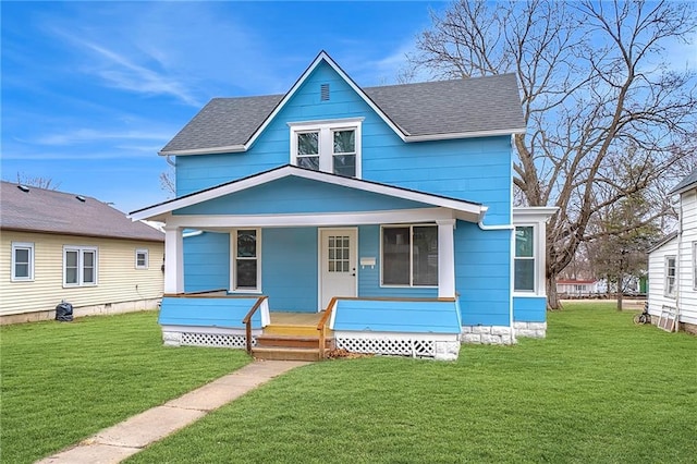 view of front of home with covered porch, a front yard, and a shingled roof