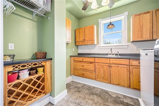 kitchen with ceiling fan, sink, and hanging light fixtures