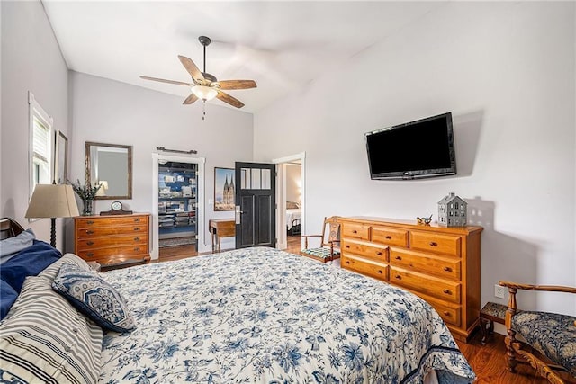 bedroom featuring vaulted ceiling, dark wood-type flooring, and ceiling fan