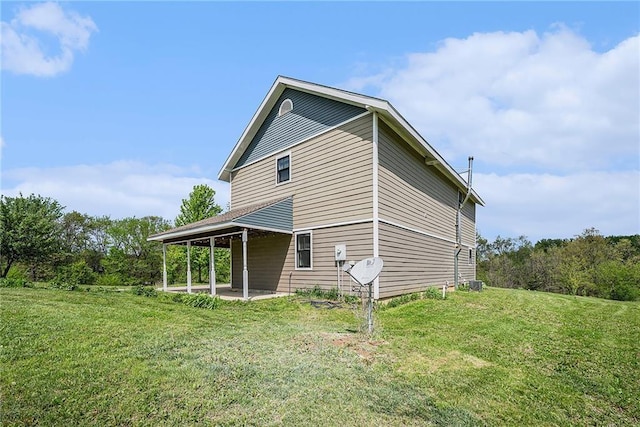 back of property featuring a yard and a patio area