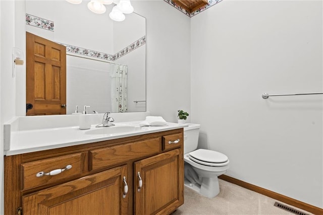 bathroom with vanity, walk in shower, and toilet