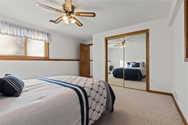 bedroom with ceiling fan, a closet, and light carpet