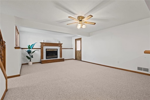 unfurnished living room featuring ceiling fan, light carpet, and a textured ceiling