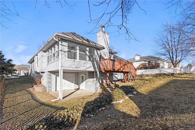 rear view of property featuring a deck