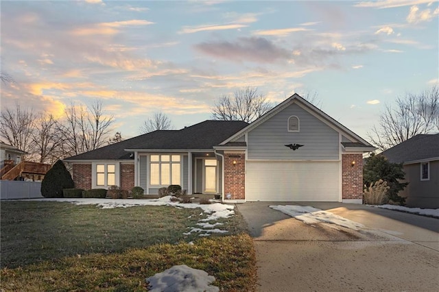 ranch-style house with a garage and a lawn