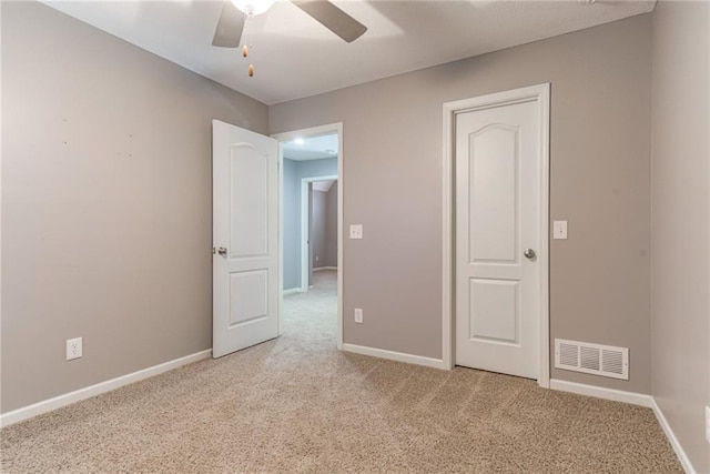 unfurnished bedroom featuring ceiling fan and light carpet