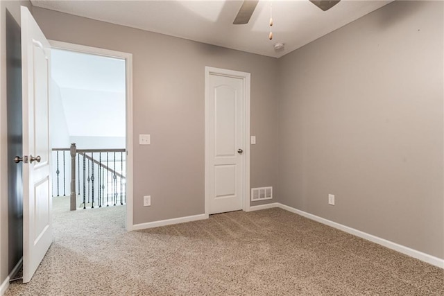 spare room featuring ceiling fan and carpet