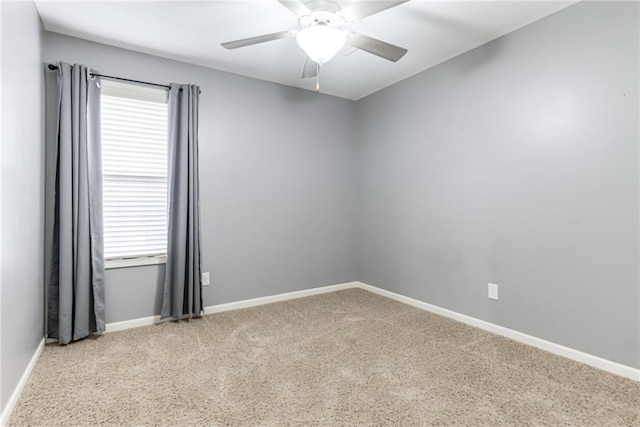 spare room with ceiling fan and light colored carpet