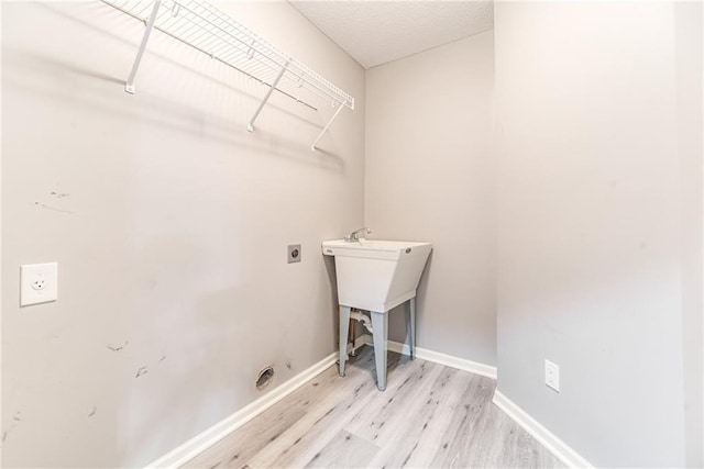 laundry room featuring light hardwood / wood-style flooring and electric dryer hookup