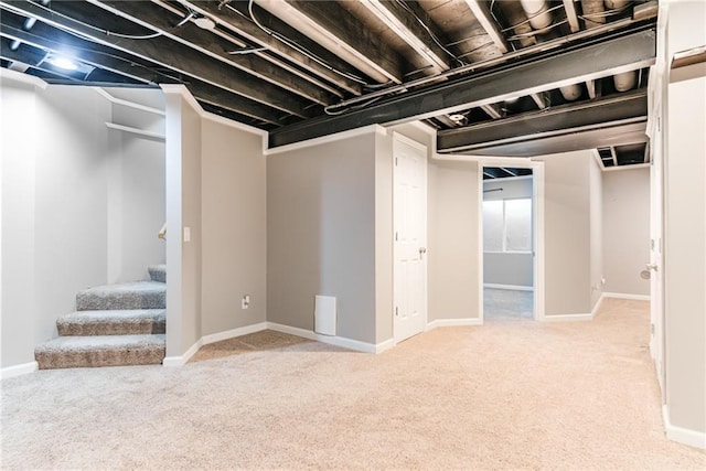 basement featuring light colored carpet