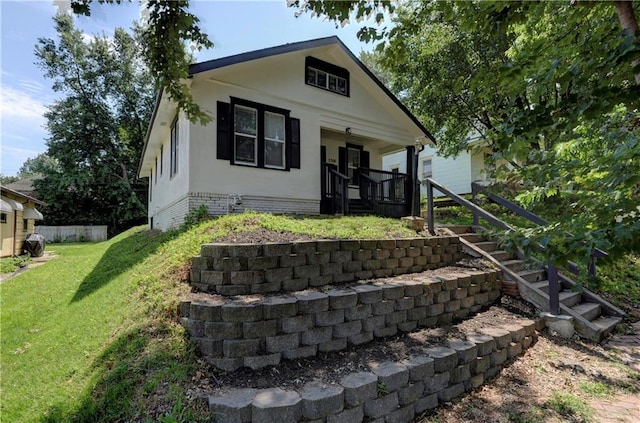 bungalow-style house with a front lawn and a porch