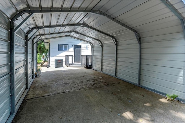 garage with central air condition unit and a carport