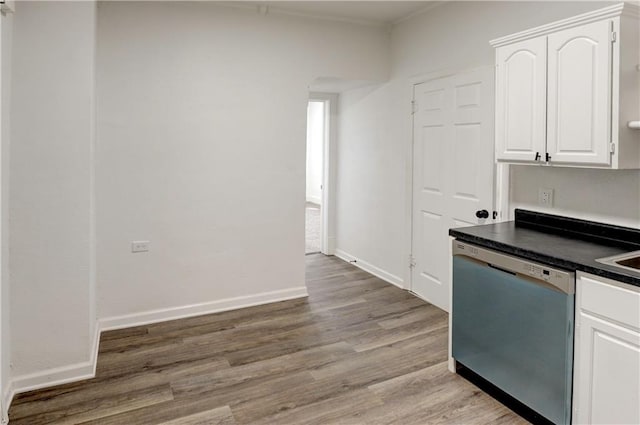 kitchen featuring white cabinetry, stainless steel dishwasher, light hardwood / wood-style flooring, and sink