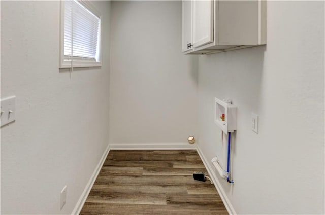 laundry room with hardwood / wood-style flooring, cabinets, and hookup for a washing machine