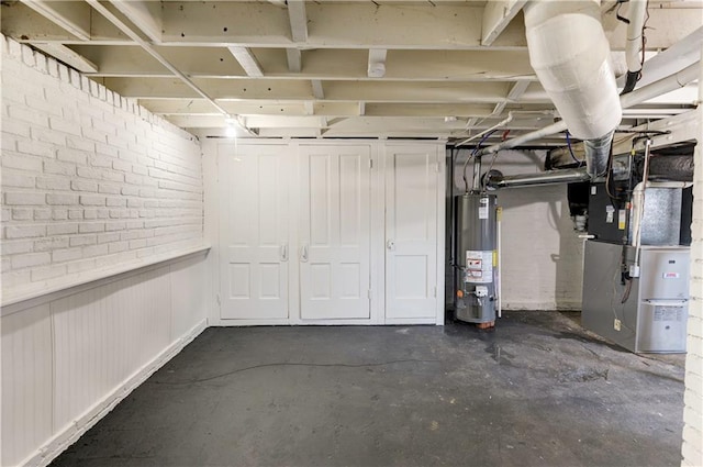 basement featuring water heater and heating unit