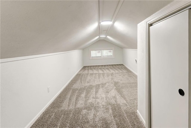 bonus room with light carpet and lofted ceiling