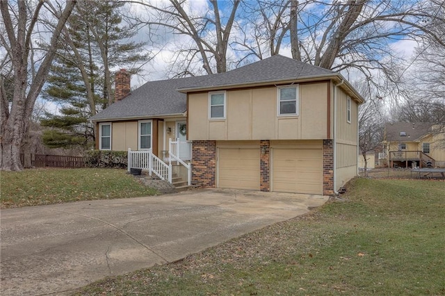 split level home with a garage and a front yard